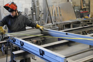 a man in a helmet working on a piece of metal