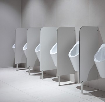 a row of white urinals in a bathroom